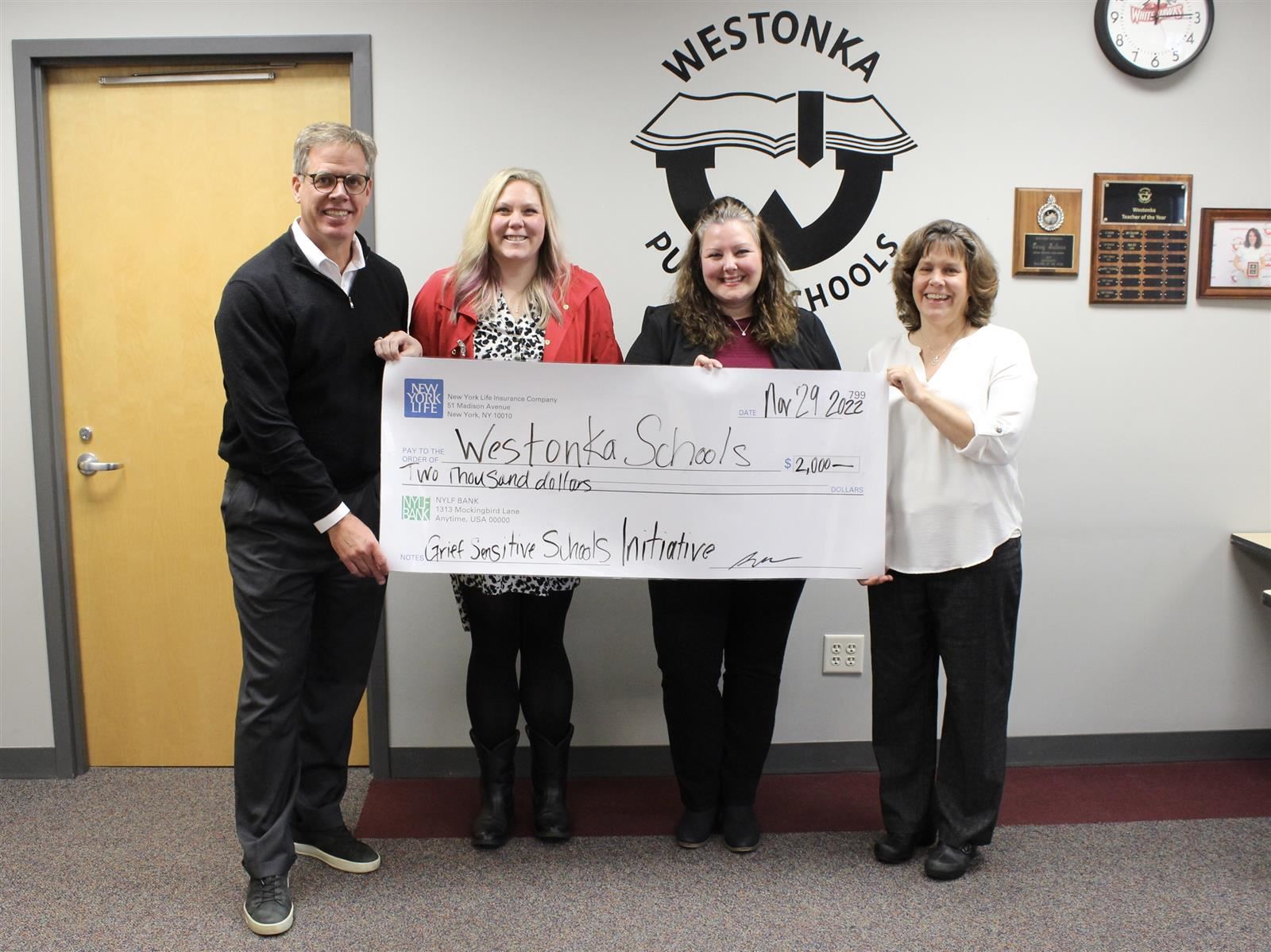  Westonka staff holding large check for Grief-Sensitive School District grant