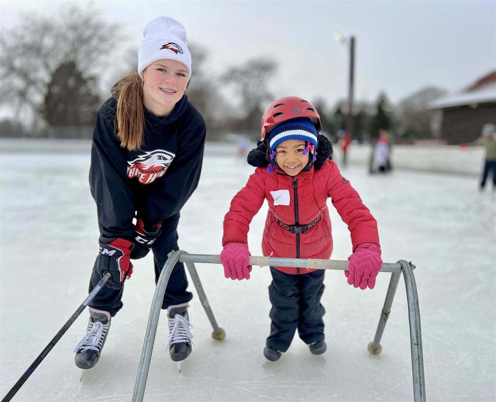  high school and elementary school students ice skating