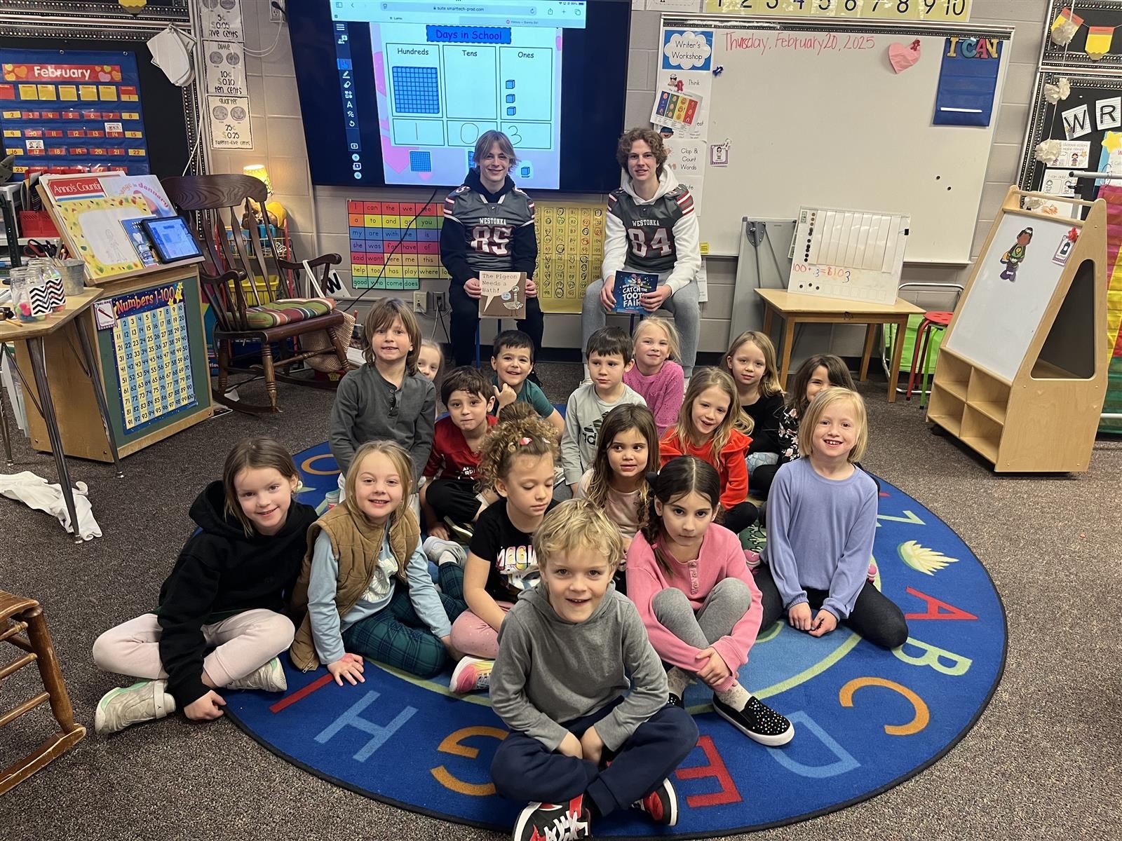  MWHS Football Players Share Love of Reading with Young Students